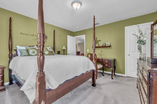 a bed room with a bed and a chair