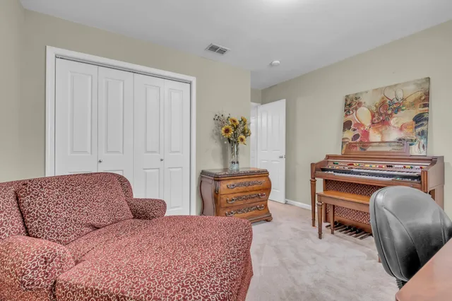 a bedroom with furniture and a dresser