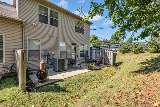 front view of a house with a chairs in patio