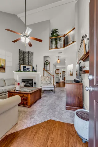 a living room with furniture and a chandelier