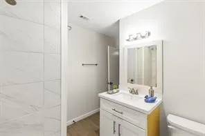 a bathroom with a sink vanity granite and a mirror