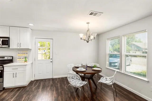 a view of a dining room with furniture window and wooden floor