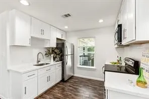 a kitchen with a sink stove and cabinets