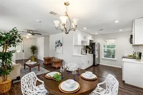 a kitchen with stainless steel appliances a table and chairs in it