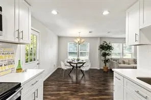 a view of a kitchen with granite countertop a large window and a counter space