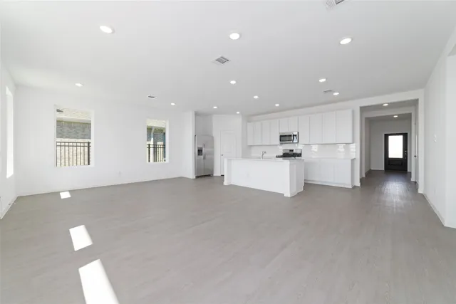 a view of a livingroom with furniture and a kitchen