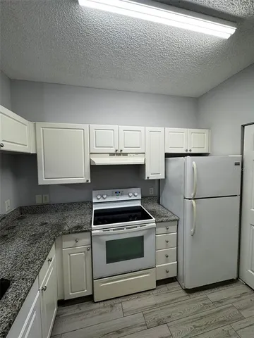 a kitchen with a stove and a refrigerator