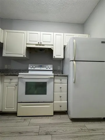 a kitchen with a stove and a refrigerator