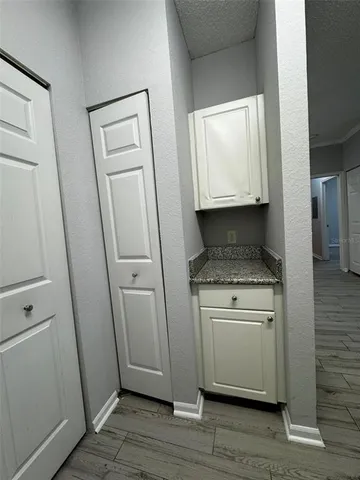 a room with wooden floor washer and dryer