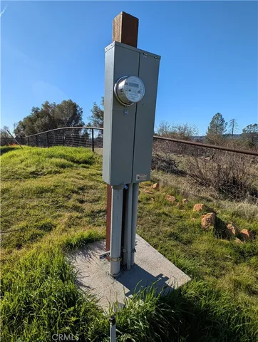 a view of a yard with wooden fence