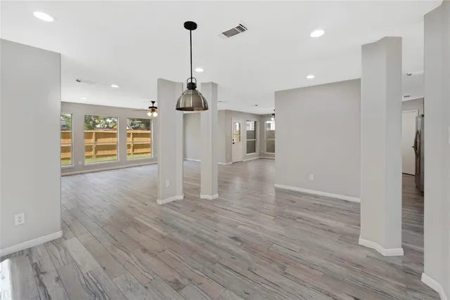 a view of a livingroom with furniture wooden floor and window