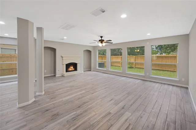 a view of a kitchen with wooden floor and a ceiling fan