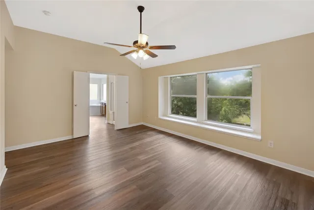 a spacious bathroom with a granite countertop sink and a mirror