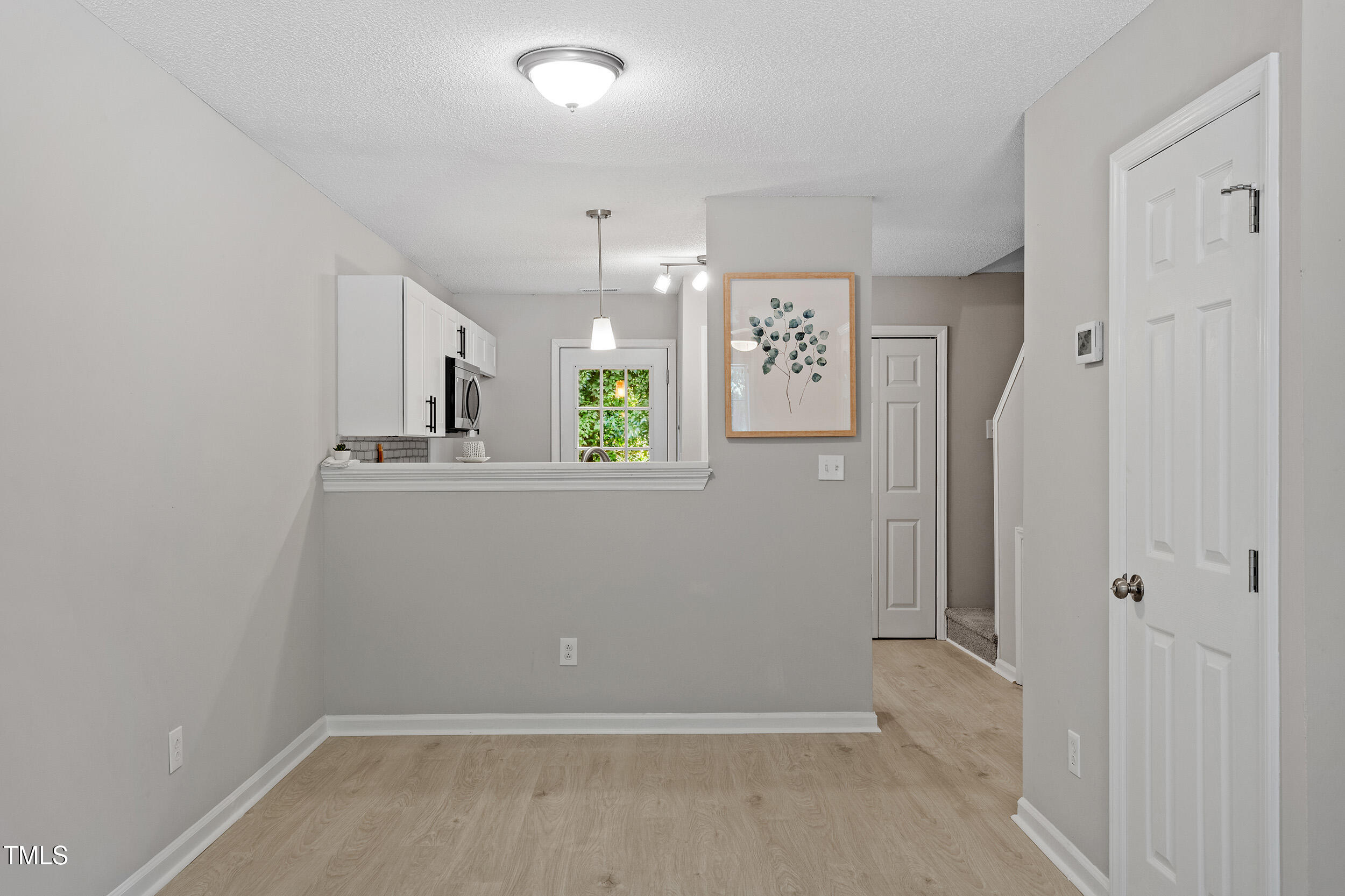 4242 Kaplan Drive Raleigh, NC 27606 - Photo 13 of 30 wooden floor in an empty room with a window