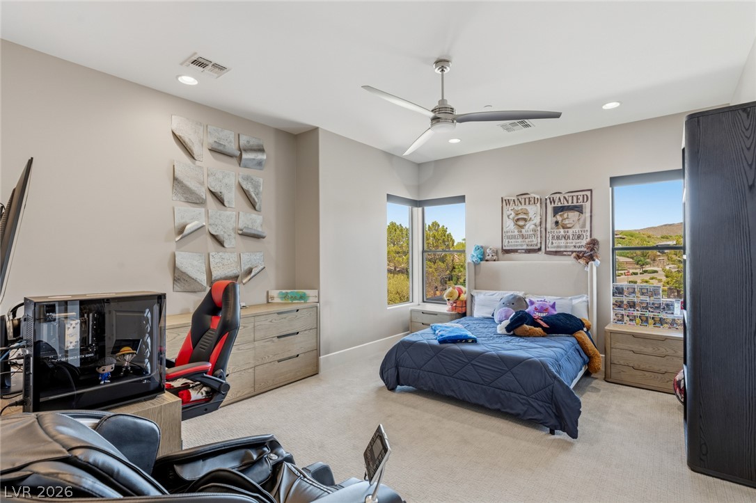5 Crystal Tree Pass Henderson, NV 89052 - Photo 29 of 67 Natural light pours into this bedroom, highlighting the plush carpeting and serene views.