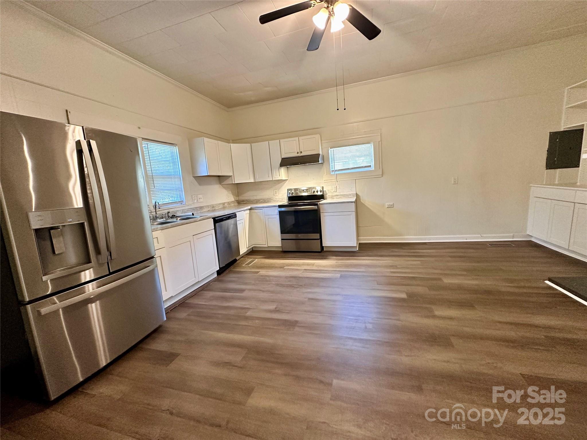 103 Fairview Street Clover, SC 29710 - Photo 13 of 24 a kitchen with stainless steel appliances wooden floor sink and wooden cabinets