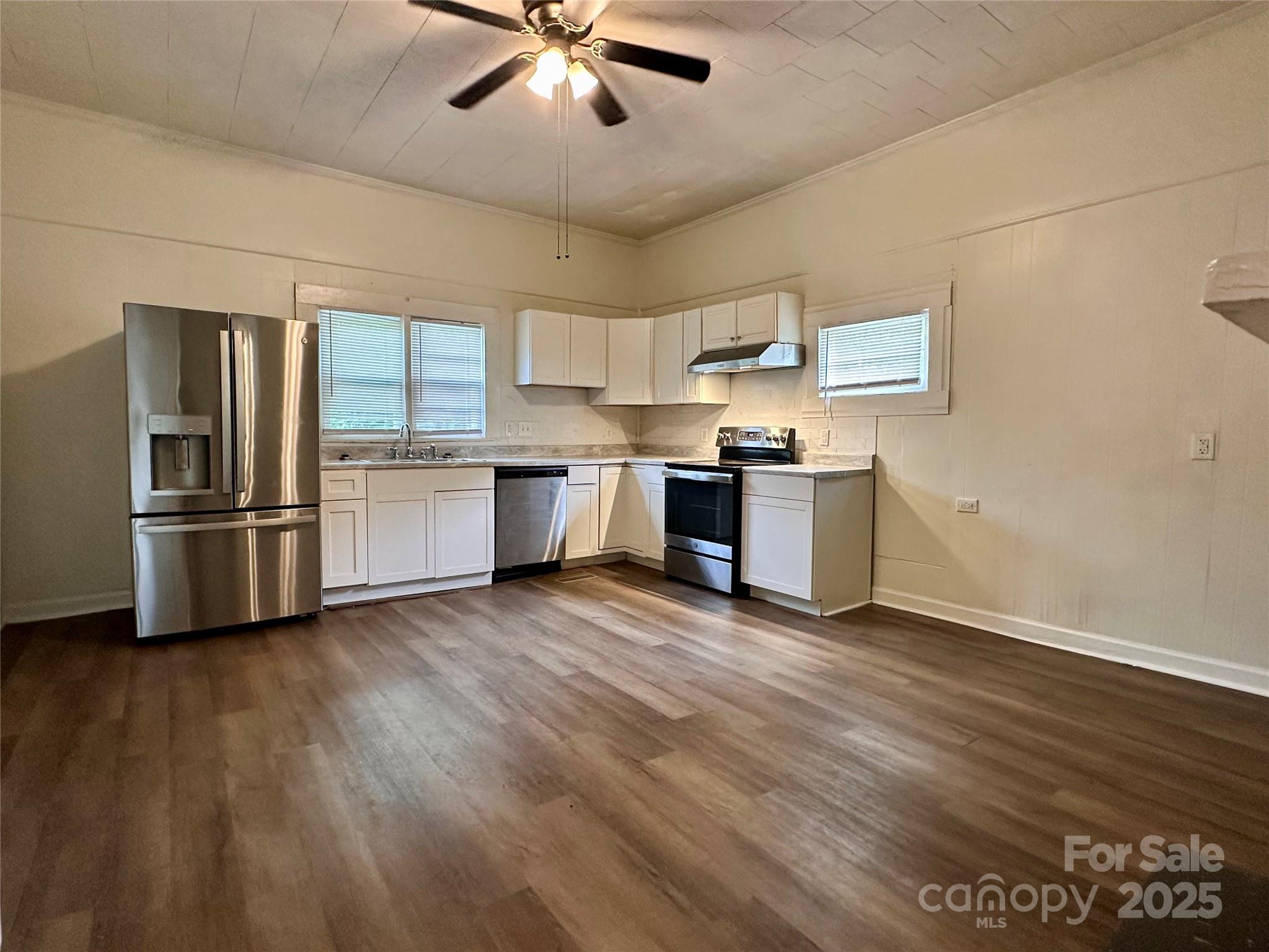 103 Fairview Street Clover, SC 29710 - Photo 14 of 24 a kitchen with stainless steel appliances granite countertop a refrigerator a stove a sink dishwasher and a oven with wooden floor