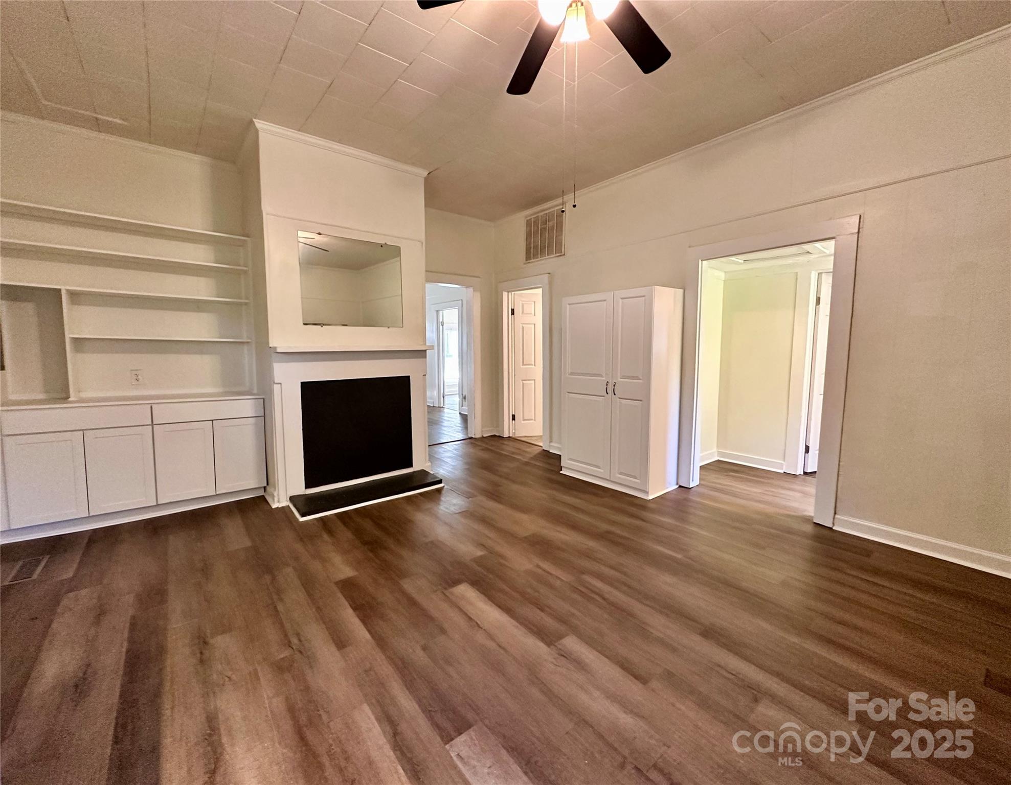 103 Fairview Street Clover, SC 29710 - Photo 15 of 24 an empty room with wooden floor fireplace and windows