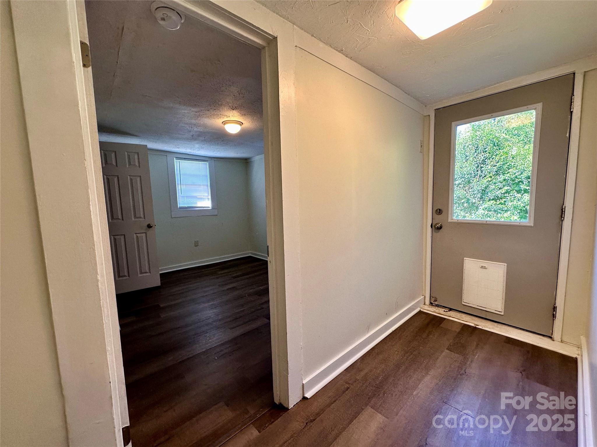 103 Fairview Street Clover, SC 29710 - Photo 17 of 24 an empty room with wooden floor and windows