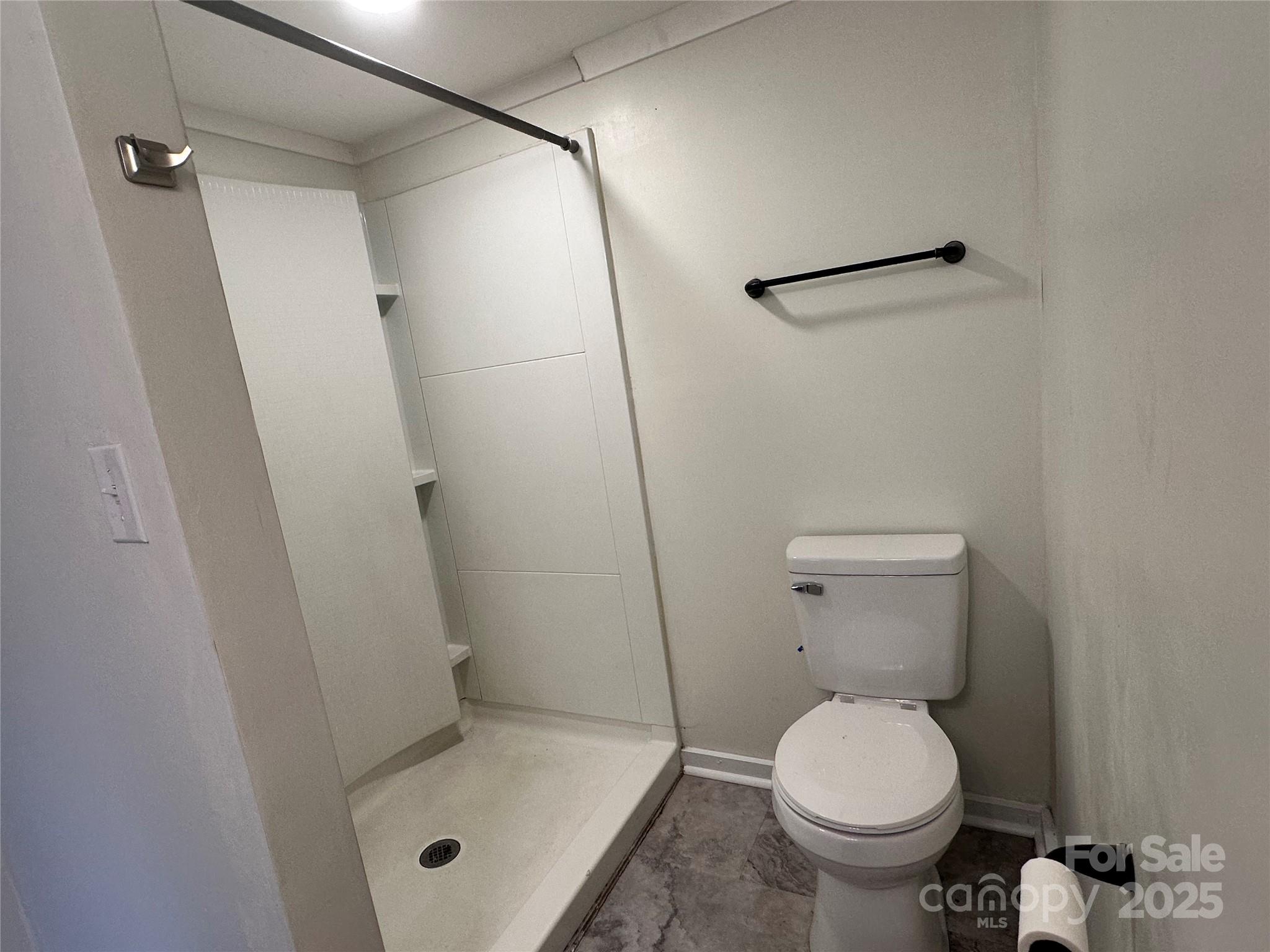 103 Fairview Street Clover, SC 29710 - Photo 18 of 24 a bathroom with a toilet and a shower