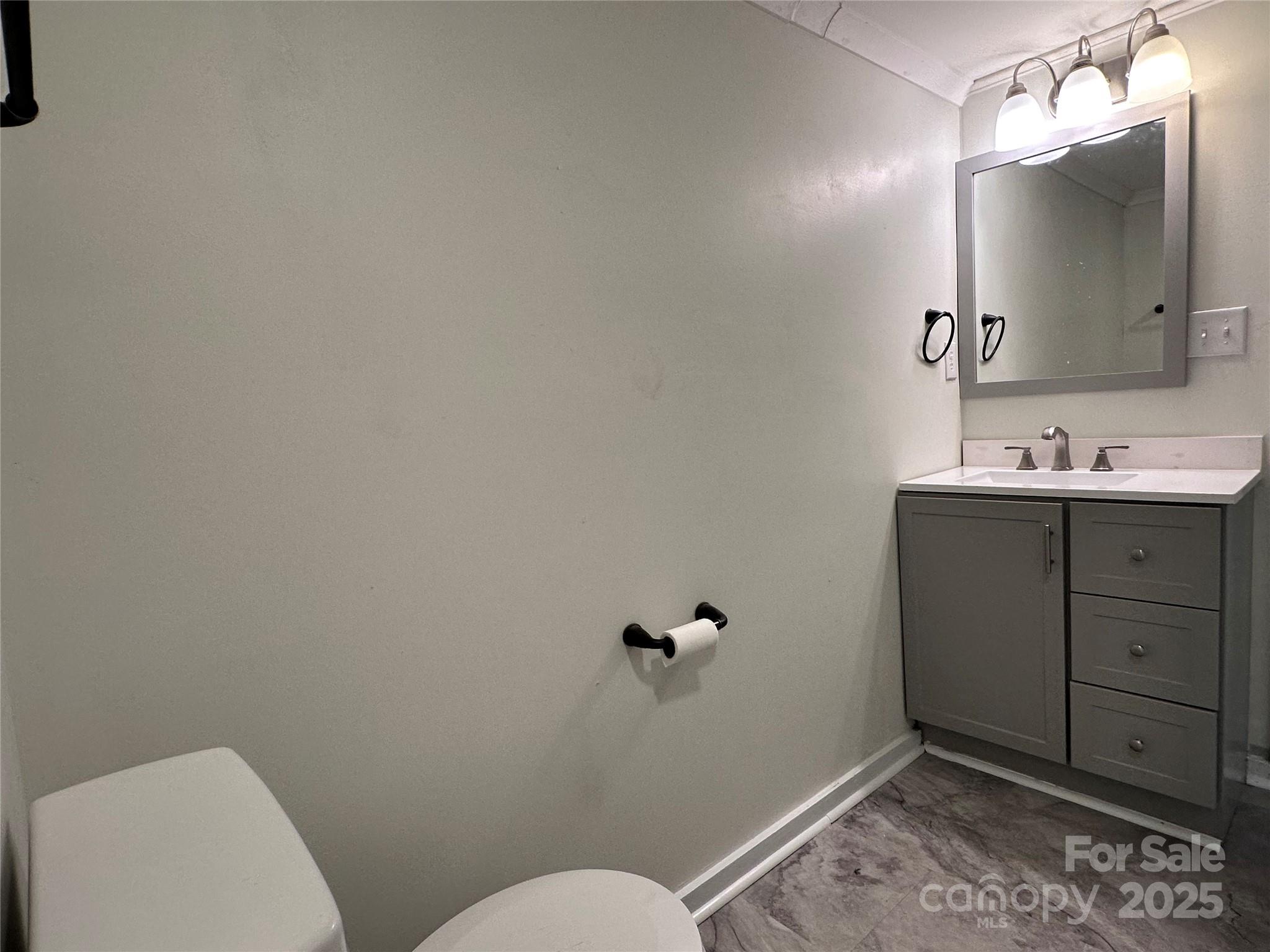 103 Fairview Street Clover, SC 29710 - Photo 20 of 24 a bathroom with a toilet sink and mirror