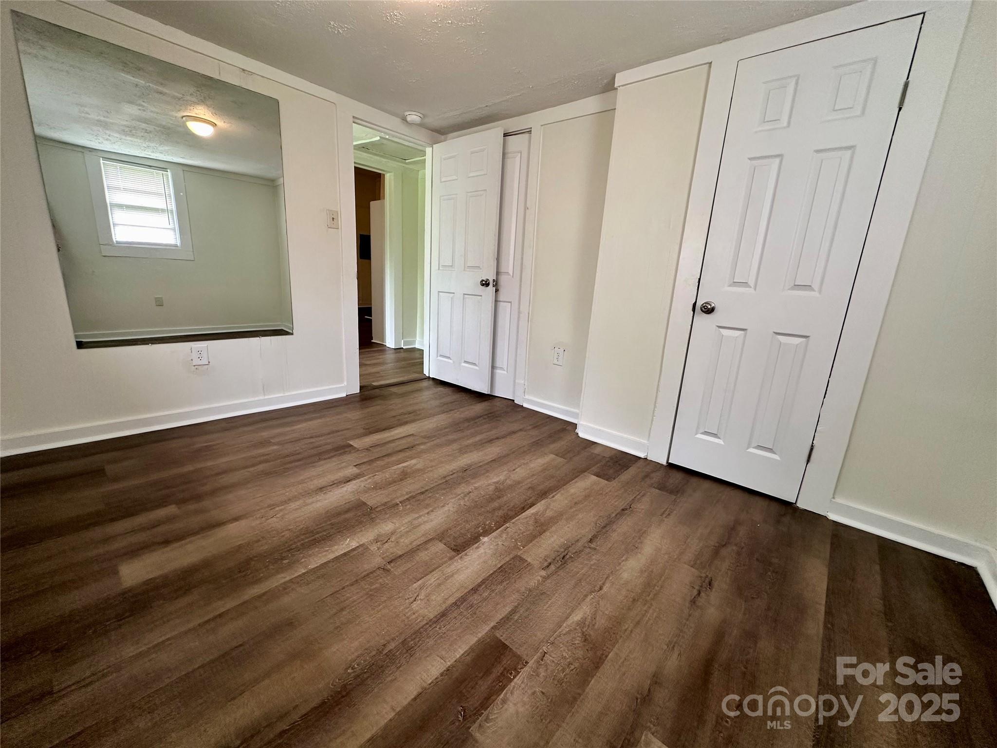 103 Fairview Street Clover, SC 29710 - Photo 22 of 24 a view of an empty room with wooden floor and a window