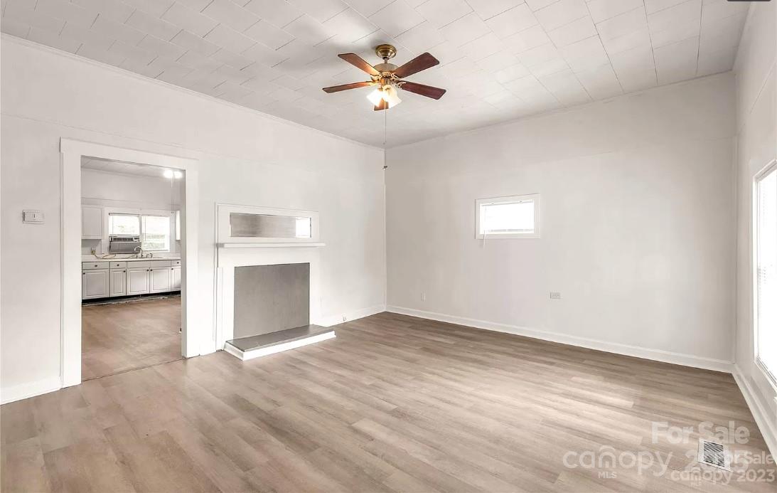 103 Fairview Street Clover, SC 29710 - Photo 7 of 24 an empty room with chandelier fan and windows