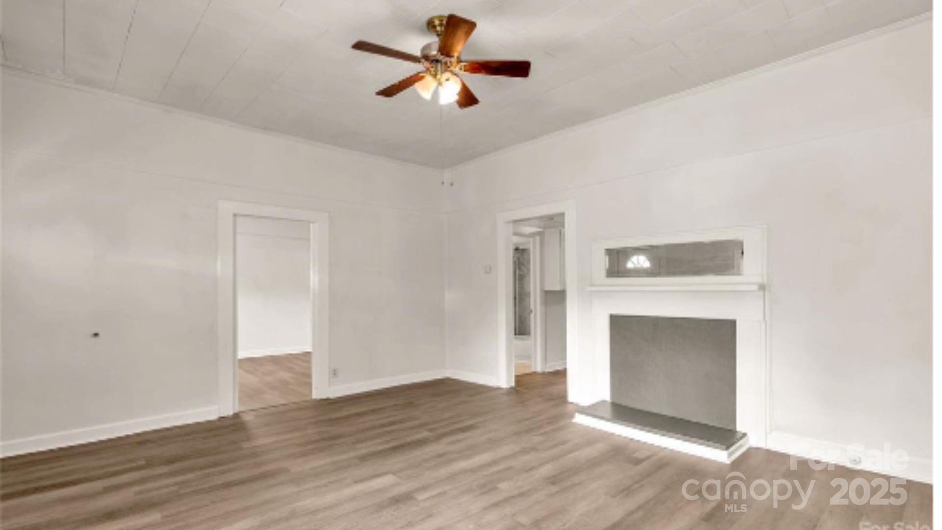 103 Fairview Street Clover, SC 29710 - Photo 9 of 24 a view of empty room with wooden floor and fireplace