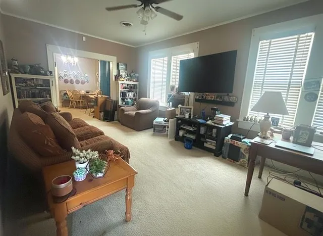 a living room with furniture and a flat screen tv