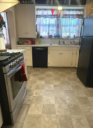 a kitchen with a stove a sink and a refrigerator