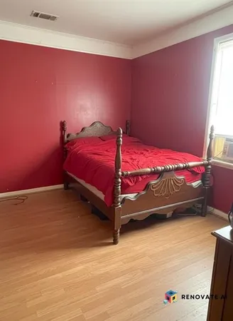 a bed sitting in a bedroom next to a window