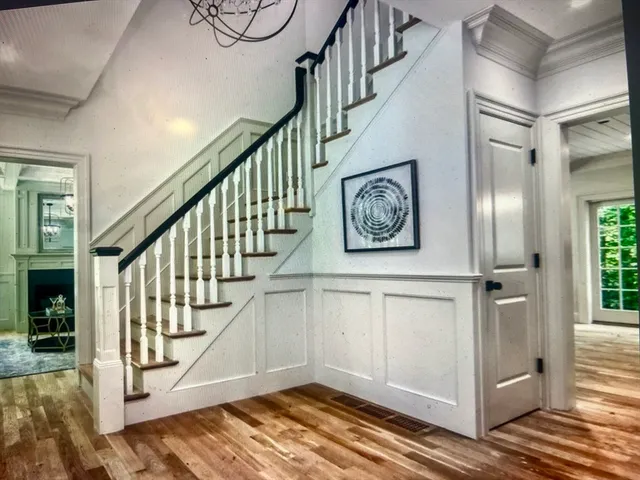 a view of entryway with wooden floor and stairs