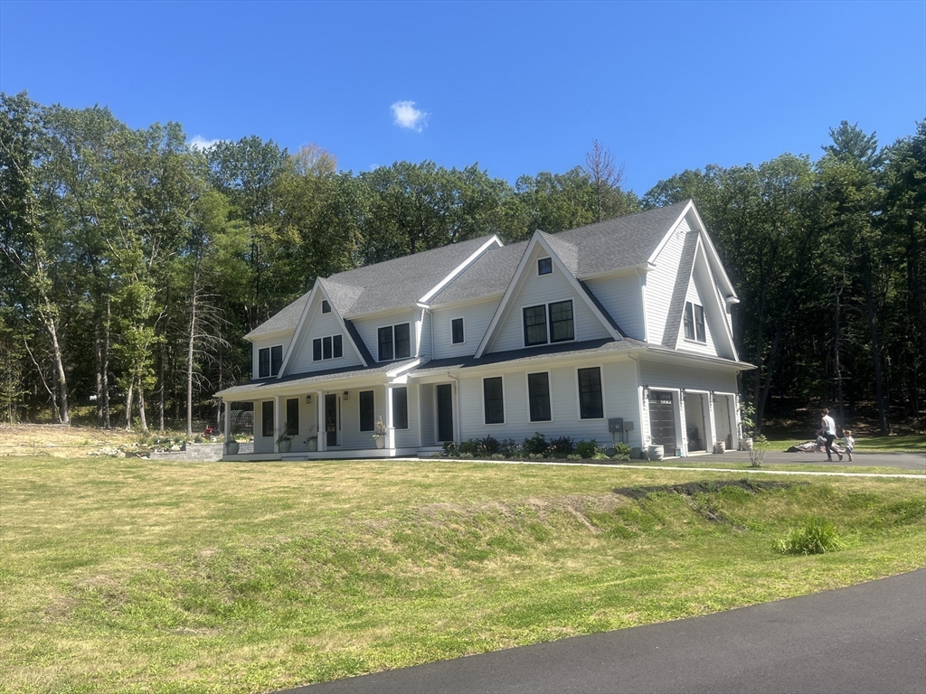 45 Widow Rites Lane Sudbury, MA 01776 - Photo 3 of 25 a front view of a house with a garden and swimming pool
