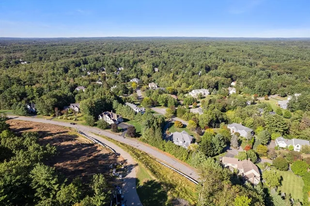 an aerial view of a houses with a yard