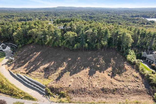 a view of a yard with wooden fence