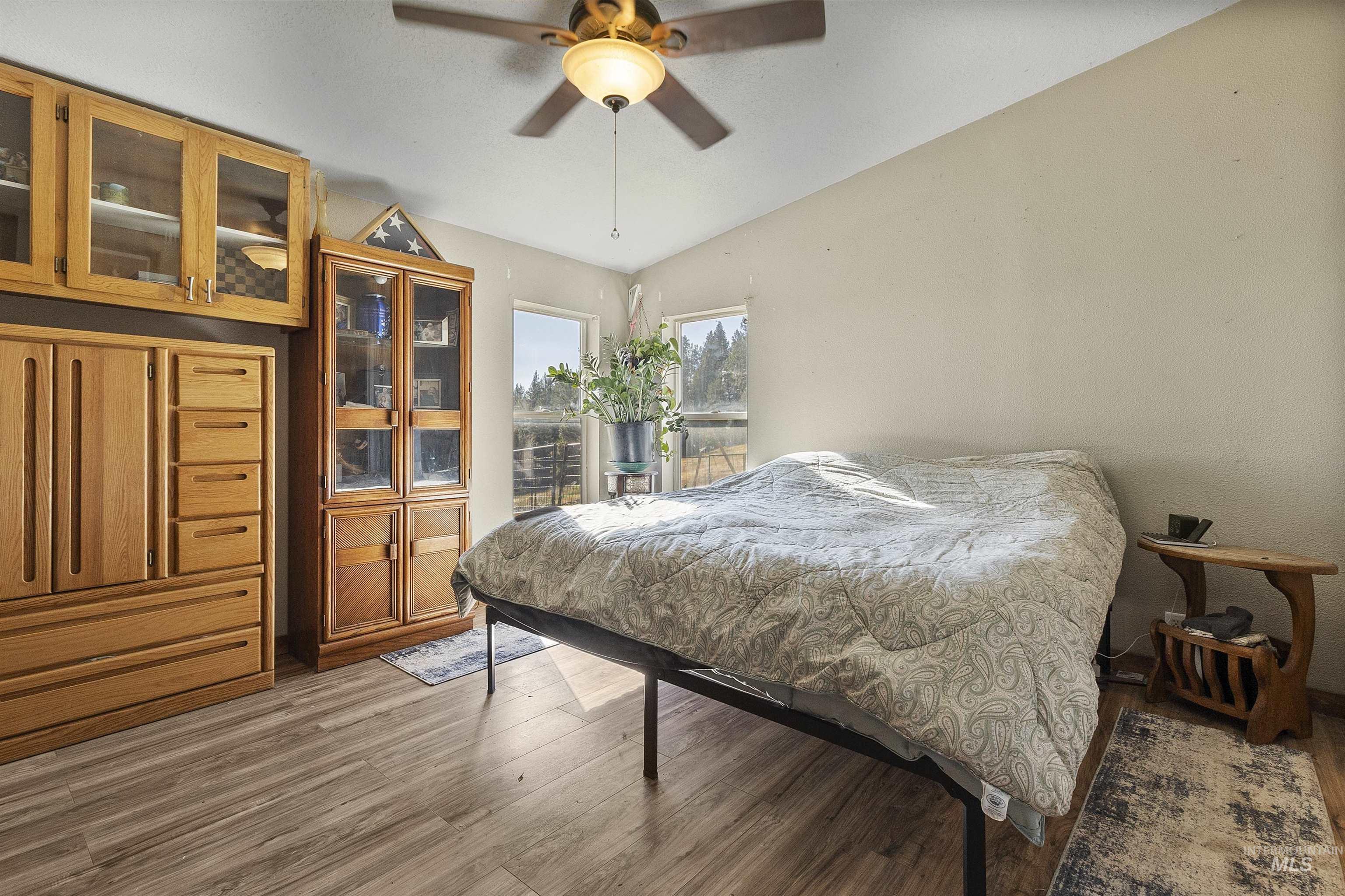 1311 Gold Hill Road Princeton, ID 83857 - Photo 15 of 25 Bedroom featuring light wood-style flooring, lofted ceiling, and a ceiling fan