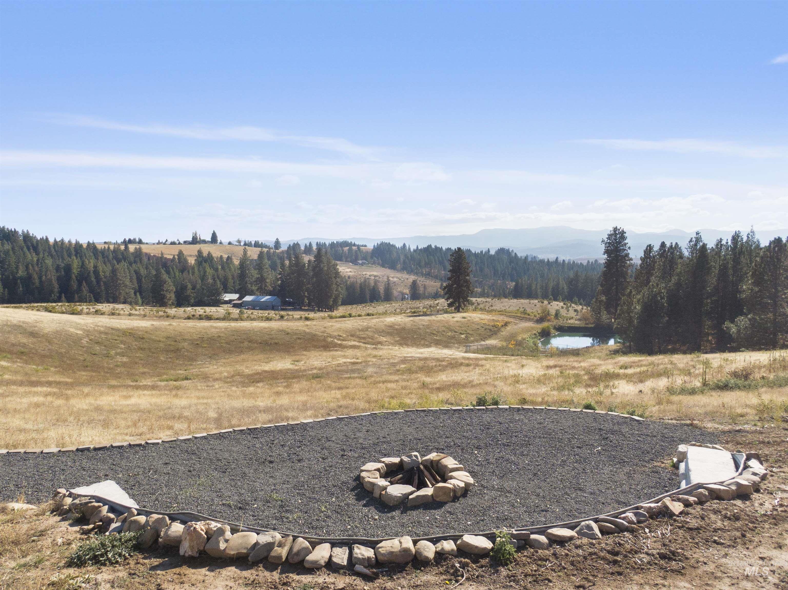 1311 Gold Hill Road Princeton, ID 83857 - Photo 21 of 25 View of yard with a water and mountain view and a fire pit