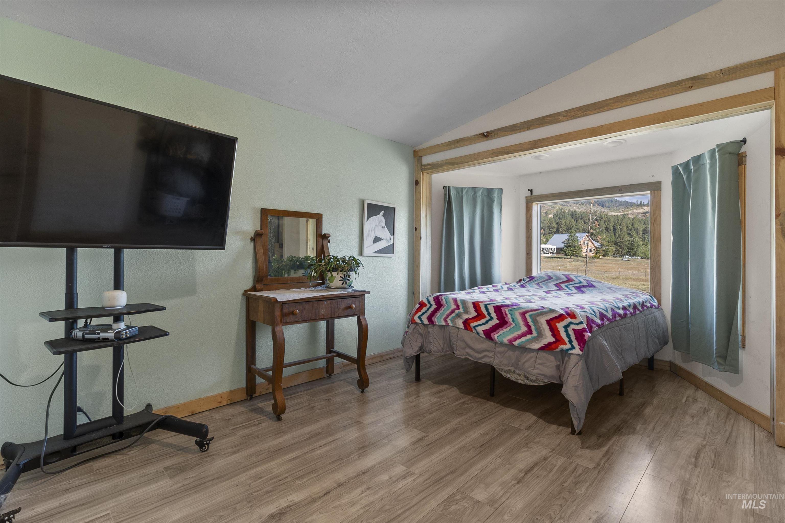 1311 Gold Hill Road Princeton, ID 83857 - Photo 5 of 25 Bedroom featuring vaulted ceiling and light wood-style flooring