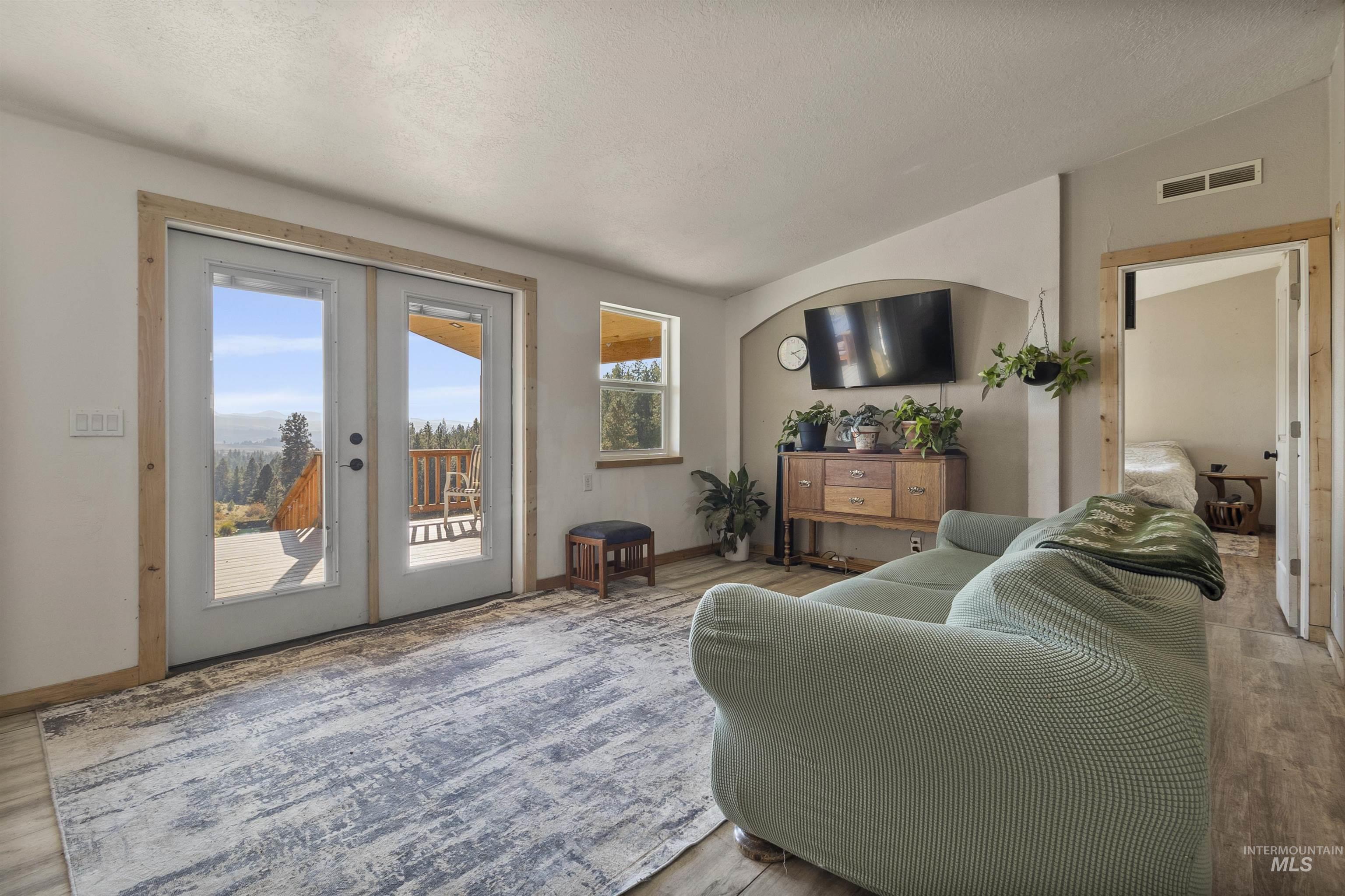 1311 Gold Hill Road Princeton, ID 83857 - Photo 10 of 25 Living area featuring lofted ceiling, wood finished floors, and french doors