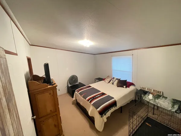 a bedroom with furniture and a window