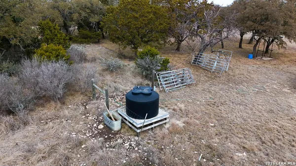 a wooden bench sitting in the middle of a yard