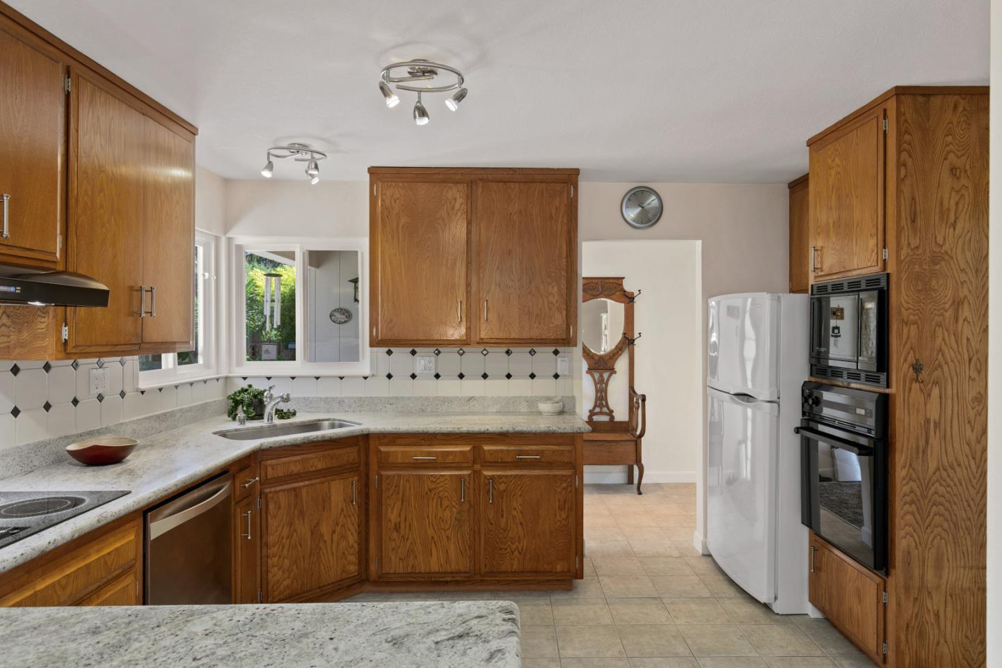 36 Robak Drive Watsonville, CA 95076 - Photo 14 of 39 a kitchen with a sink refrigerator and cabinets