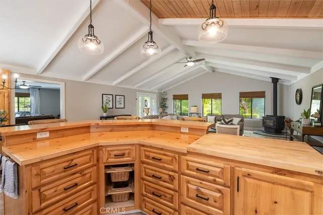 a view of a kitchen with stainless steel appliances granite countertop a sink and cabinets