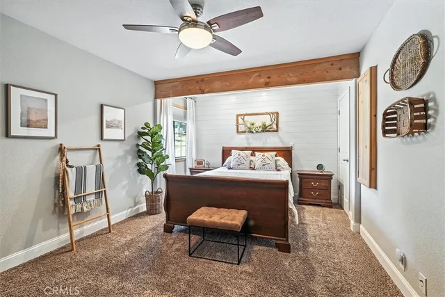 a bedroom with a bed and a potted plant