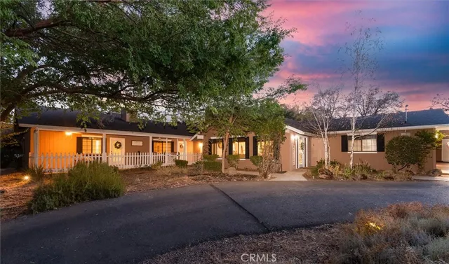 a front view of a house with a yard and outdoor seating