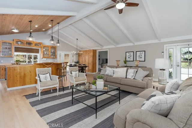 a living room with furniture and a view of kitchen