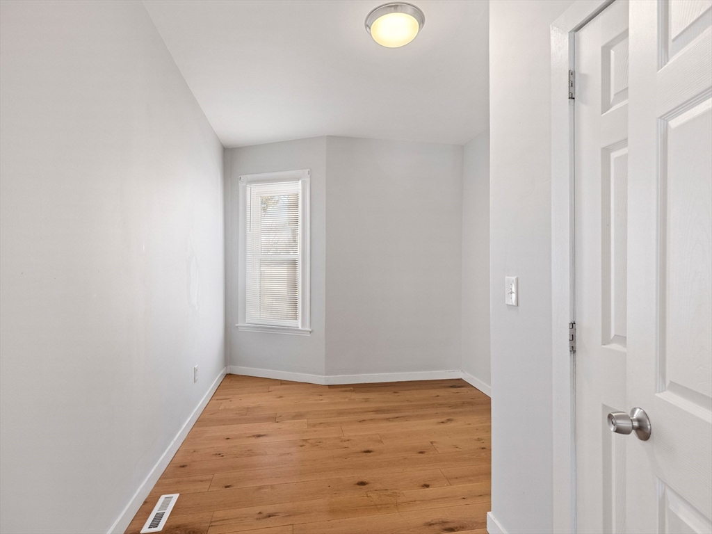 37 Howard Street Lynn, MA 01902 - Photo 13 of 42 a view of a room with wooden floor and mirror