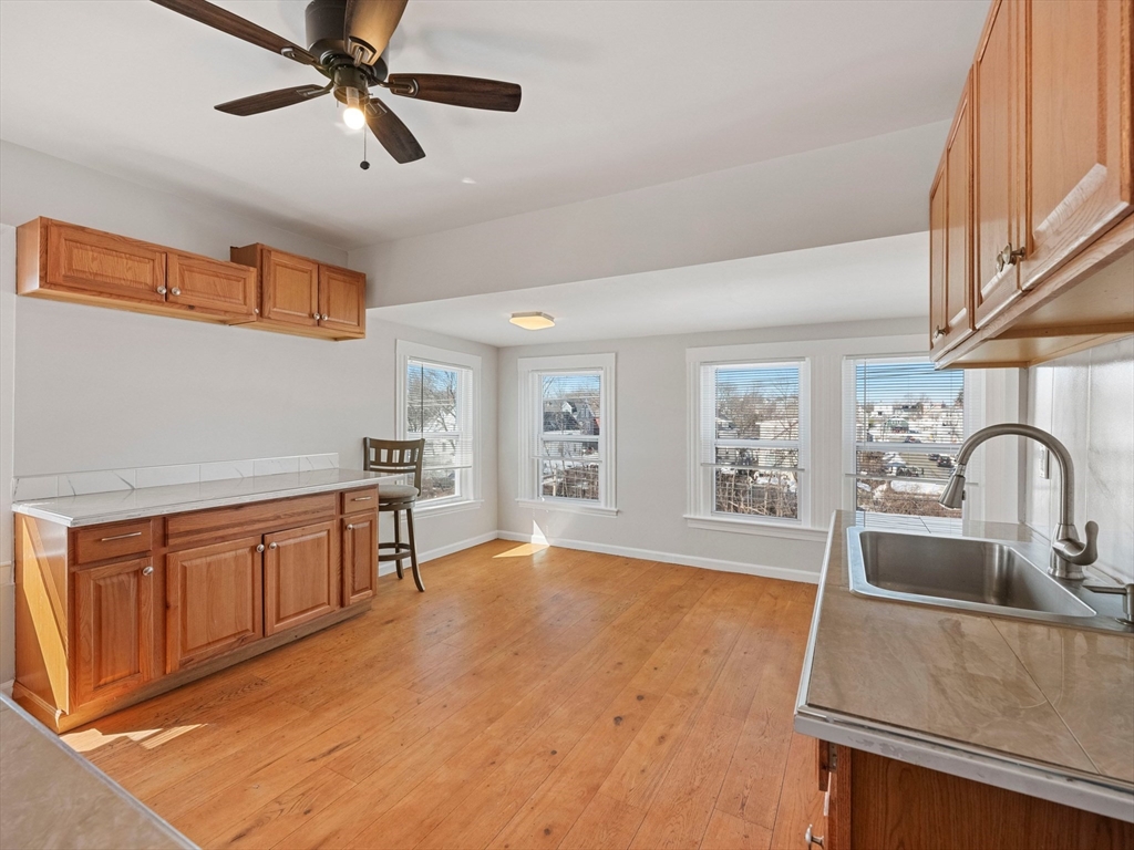 37 Howard Street Lynn, MA 01902 - Photo 25 of 42 a kitchen with stainless steel appliances granite countertop a sink a stove cabinets and wooden floor