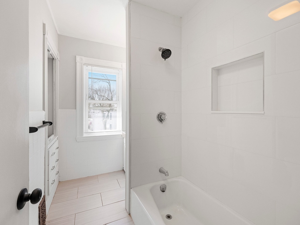 37 Howard Street Lynn, MA 01902 - Photo 30 of 42 a bathroom with a bathtub and a shower