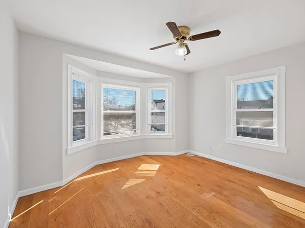 a view of hallway with wooden floor and stairs